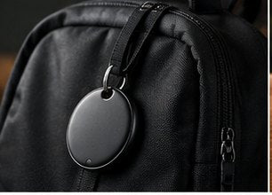 TECHSAFE Tag hanging from the zip pull of a black backpack.
